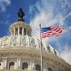 US capitol with flag and blue sky