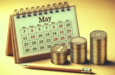 Coins stacked next to the May calender