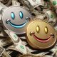 two smiling coins playing with money