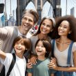 family standing happy taking a selfie at a restaurant table