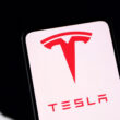 Tesla logo displayed on smartphone screen