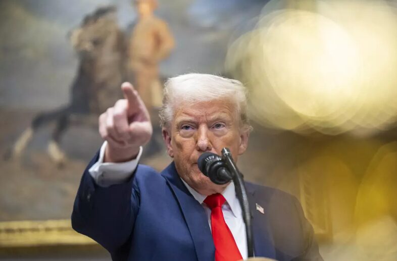 President Trump speaking at podium with raised finger