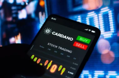 Smartphone displaying Cardano trading interface with buy and sell buttons