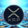 XRP coin with logo displayed against blue digital background
