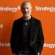 Michael Saylor standing in front of orange Strategy branded wall