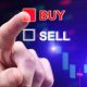 Close-up of a person's hand selecting the "BUY" option in red over the "SELL" option in white