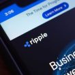 Ripple logo displayed on smartphone with financial interface