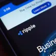 Ripple logo displayed on smartphone with financial interface