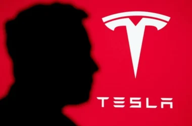 Tesla logo on red background with silhouette shadow
