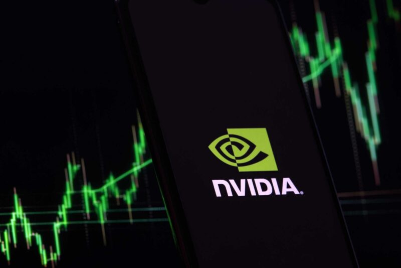 NVIDIA logo with stock market chart in green on dark background