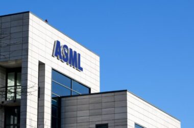 ASML logo on white office building against blue sky