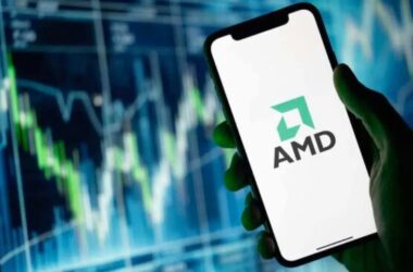 Smartphone displaying AMD logo with stock chart background
