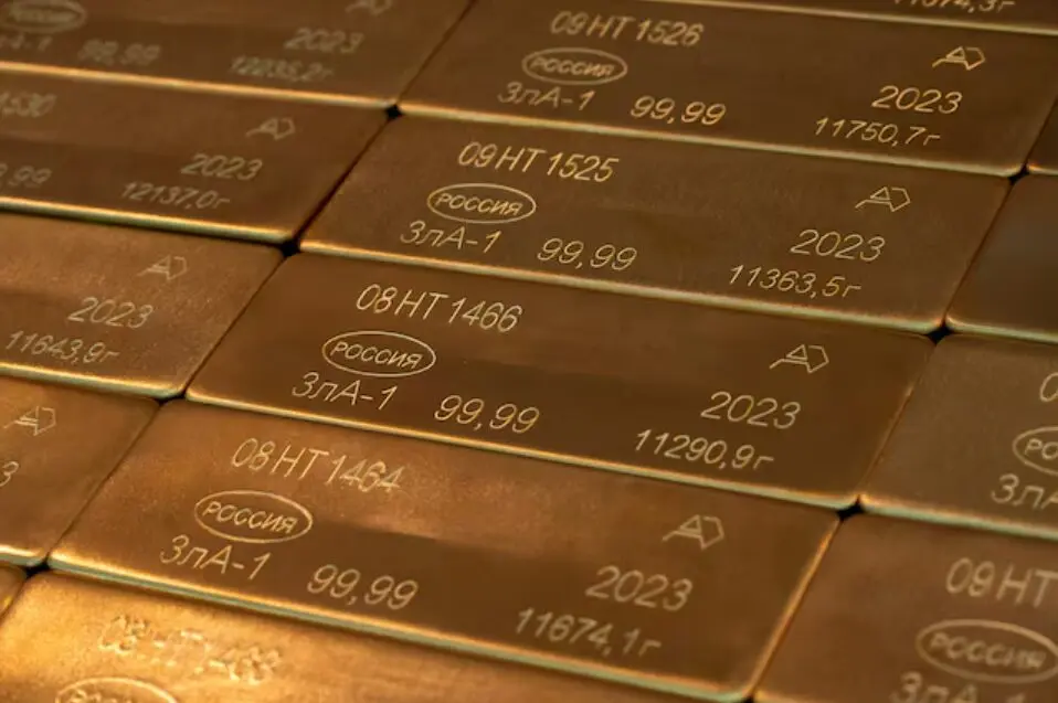 Close-up of gold bars showing 99.99% purity markings