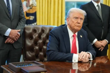 President Trump sitting at desk in Oval Office
