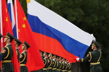 Chinese and russian soldiers with flags