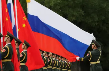 Chinese and russian soldiers with flags