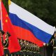 Chinese and russian soldiers with flags