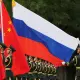 Chinese and russian soldiers with flags