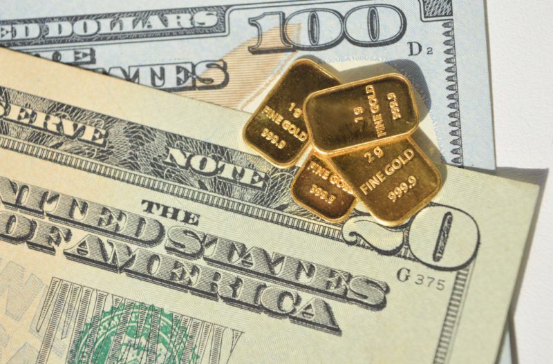 Gold bars and US dollars
