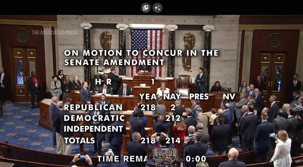 House chamber during final vote showing 218-214 results