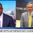 Bloomberg interview split screen showing host and Western Union CEO Devin McGranahan discussing crypto law to mitigate costly, slow money transfers
