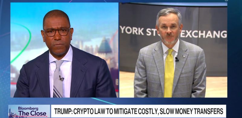 Bloomberg interview split screen showing host and Western Union CEO Devin McGranahan discussing crypto law to mitigate costly, slow money transfers