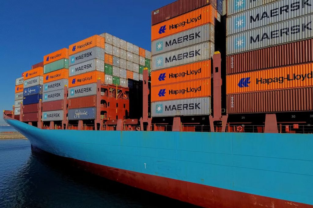 Large container ship with Maersk and Hapag-Lloyd containers at port