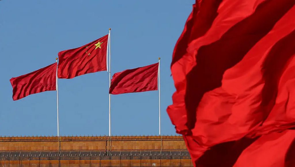 Multiple Chinese flags on flagpoles