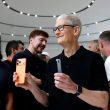 Cook holding iPhone 17 at event
