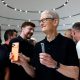 Cook holding iPhone 17 at event