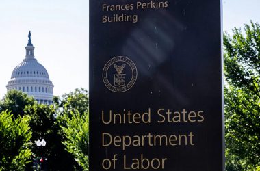 US Department of Labor building sign with Capitol in background