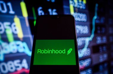 Robinhood logo on phone with charts background
