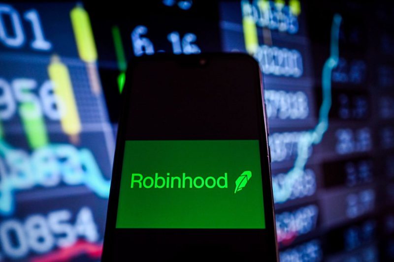 Robinhood logo on phone with charts background