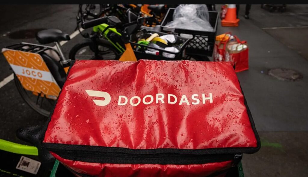doordash food delivery rider with company bag